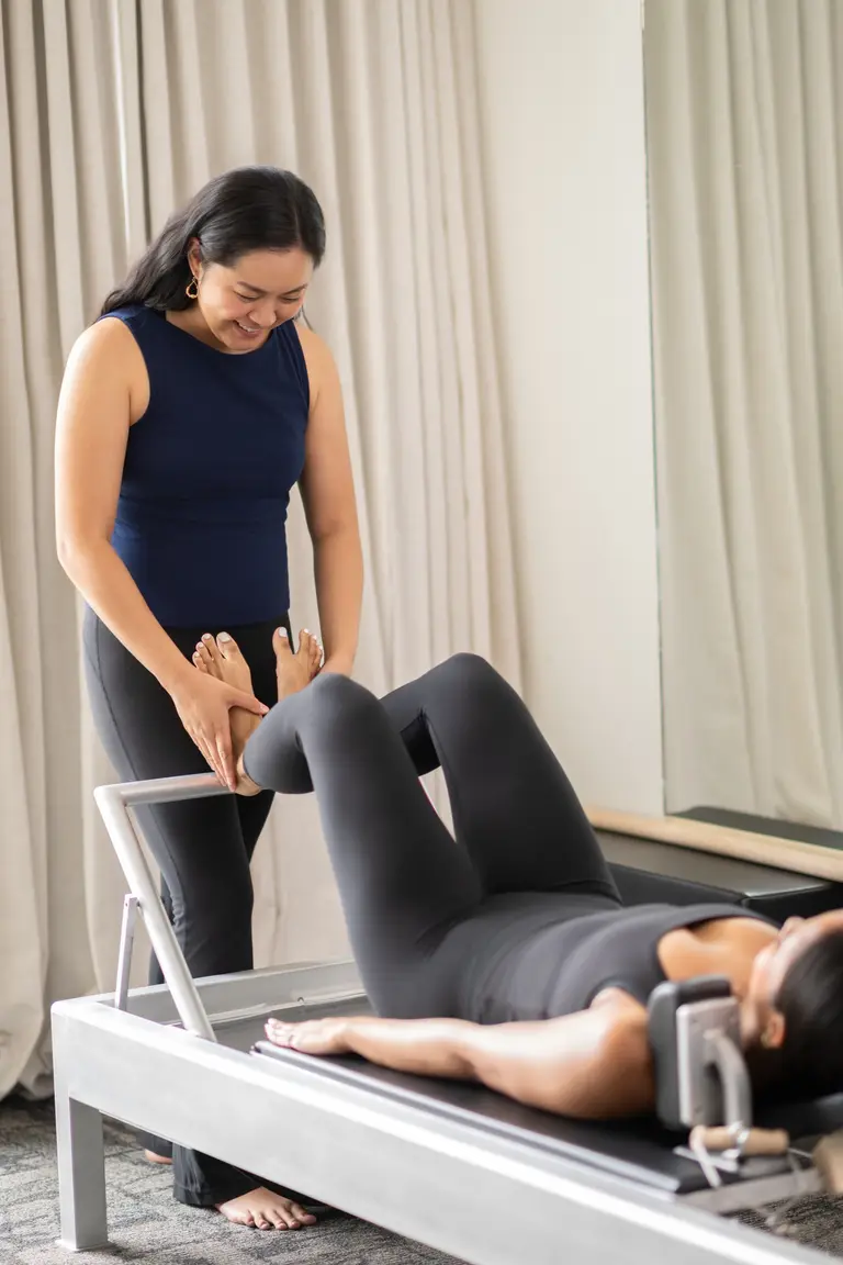 Teya teaching a private session with a client on a reformer
